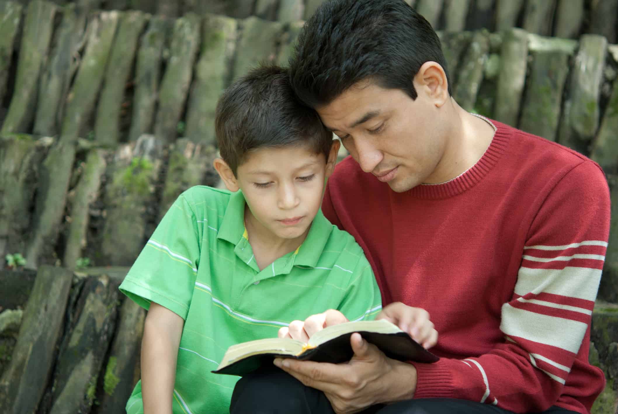 Father and son studying the bible